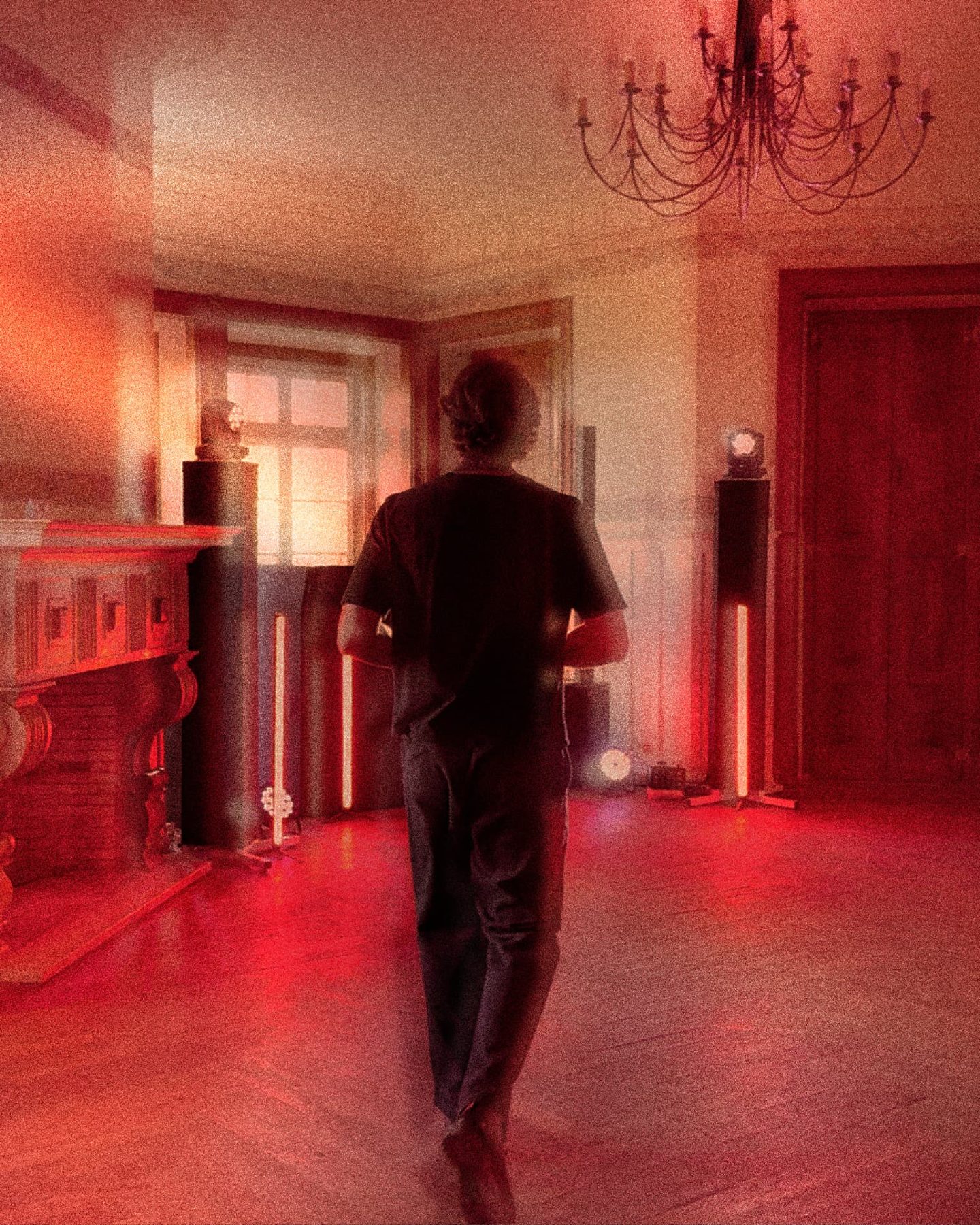 Backline and uplights set up in a red-lit room